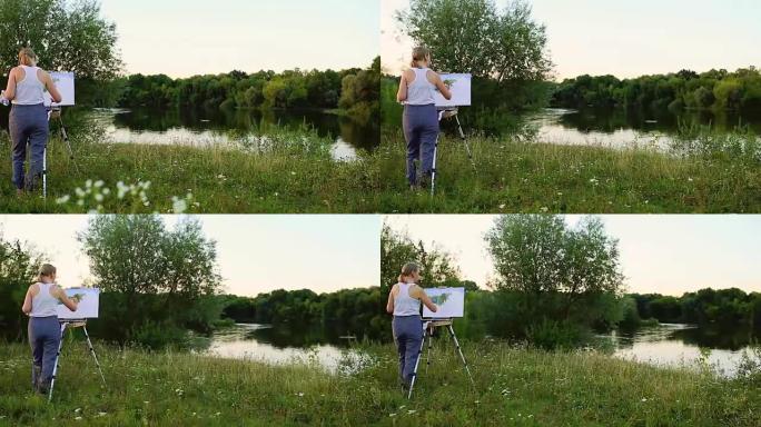 一位手握画笔和polytray的女艺术家在大自然的背景下在画布上画画。艺术家在画架上画画。工作中的艺