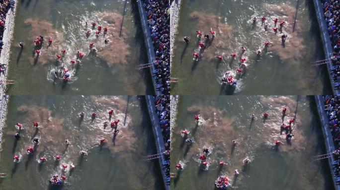 东正教游泳者跳入冰冷的水中，以取回在主显节庆祝活动中投掷的木制耶稣受难像。圣约翰十字架的传统宗教游泳
