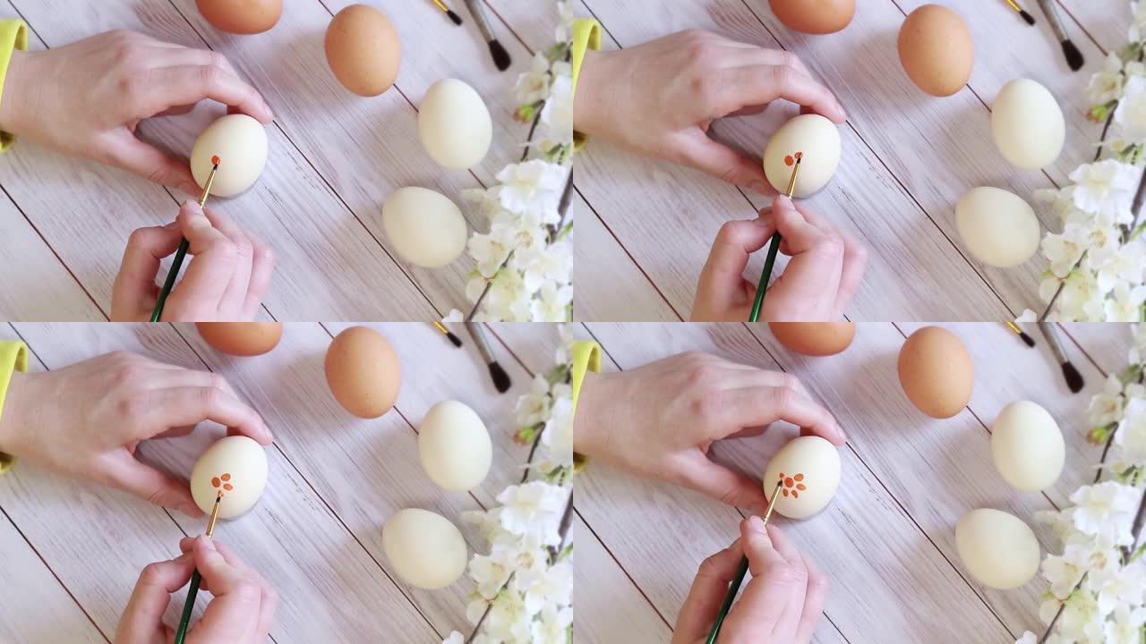 上色鸡蛋，顶视图。女人的手，为复活节做准备。复活节快乐