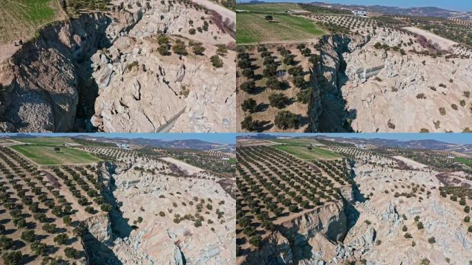 由于土耳其地震中的断层破裂，哈塔伊橄榄树林发生重大滑坡。碎粘土块和岩石的鸟瞰图。
