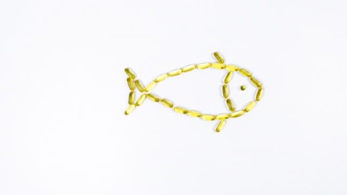 从白管，鱼跳出来，由黄色透明胶囊和鱼油，欧米茄3。鱼游泳，移动鳍。白色背景。