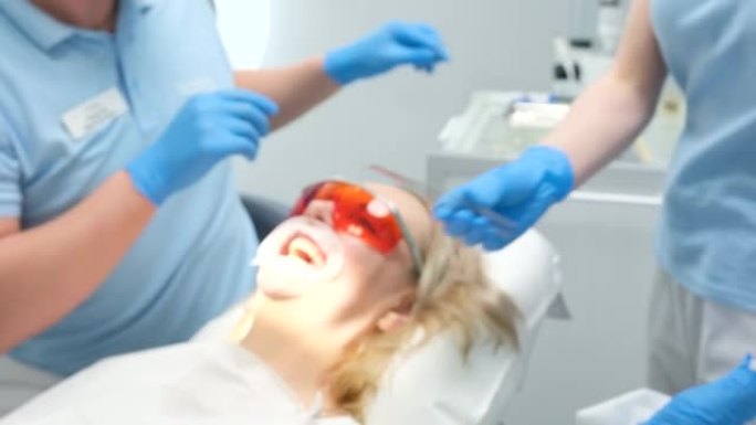 在牙科诊所中去除患者牙齿的干燥液体围堰在美白护目镜使用光聚合物灯后，从活性物质中清除保护