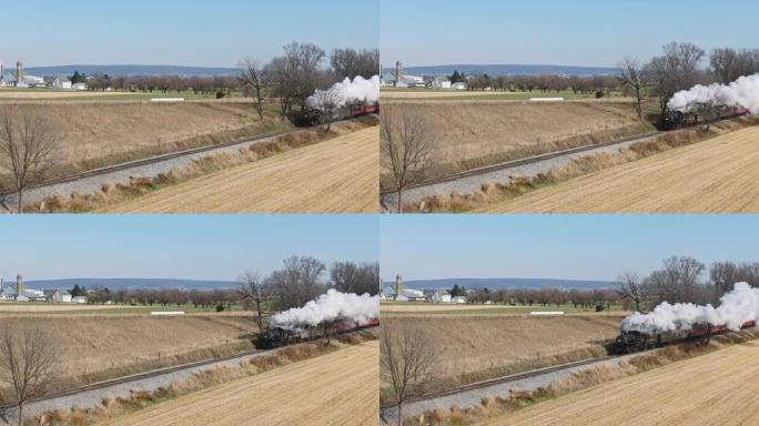 沿单列火车轨道接近的蒸汽旅客列车的鸟瞰图