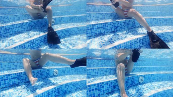 女孩在游泳池里脱下软条的水下视图