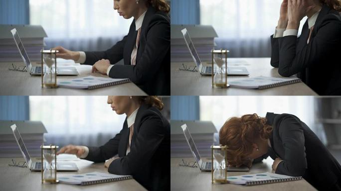 女商人看着笔记本电脑，躺在桌子上，精疲力尽，最后期限的压力