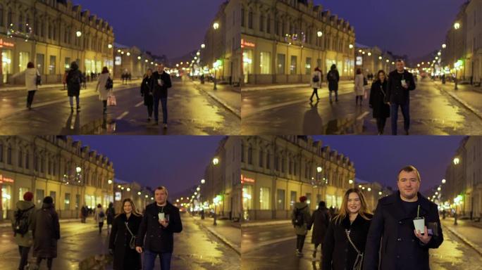 恋爱中的年轻夫妇在傍晚的城市街道上散步