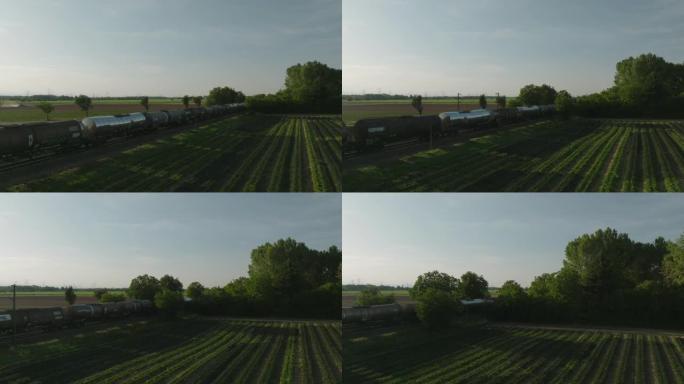 空中无人机拍摄了一列货运列车穿过农田