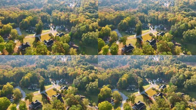 从南卡罗来纳州郊区黄色秋天树木之间的昂贵住宅上方观看。美国梦homes作为美国郊区房地产开发的例子
