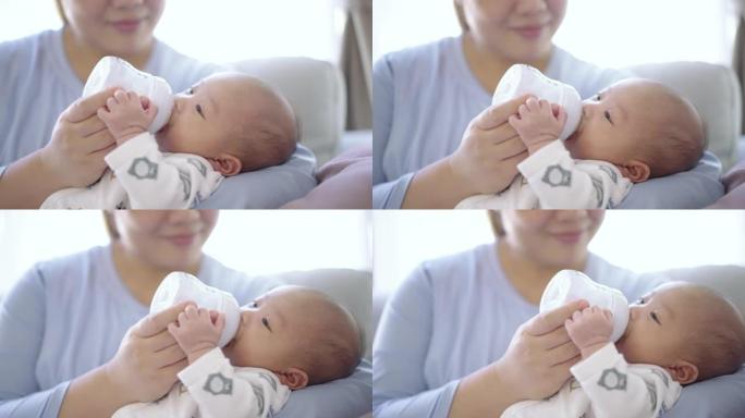 母亲用婴儿奶瓶喂养婴儿