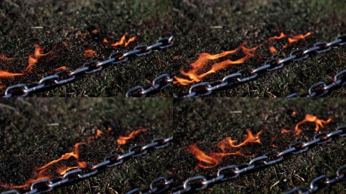 铁链附近有火燃烧的草特写4k电影慢动作