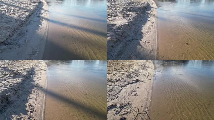 冬季沙箱的沙滩景观。无人机的垂直视图。沿海地区有干净的水。涟漪将纹理复制到沙子中。水蚀，低海拔，步行