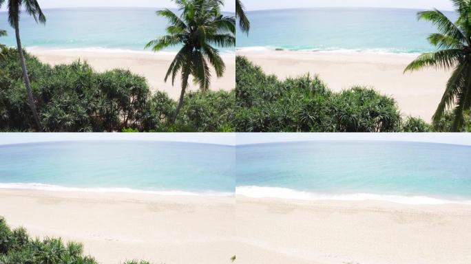 4k飞出无人机画面显示美丽的开阔海洋和海岸，上面有棕榈树。放松，自然，自然和假期概念。斯里兰卡坦加勒