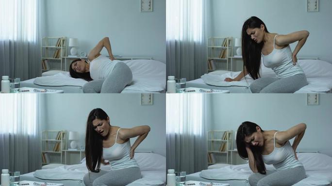 女性躺在床上遭受严重的背痛，受伤的后果