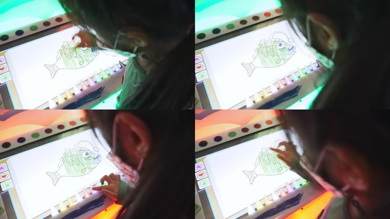 亚洲女孩在游戏屏幕上绘画。
