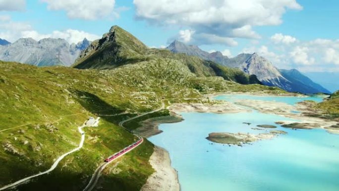 空中无人机4k。红色瑞士火车比安科湖。通往圣莫里茨的瑞士阿尔卑斯山风景路线。瑞士夏季旅游。