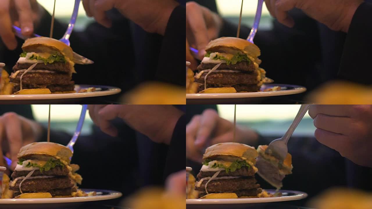 男人切汉堡片吃，快餐和肥胖，特写