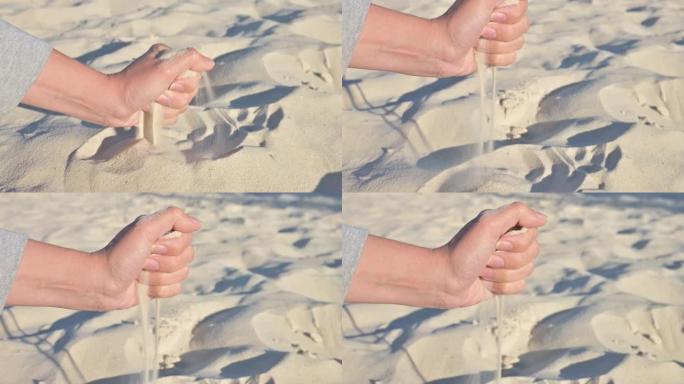 女人用手筛沙子。4k视频片段