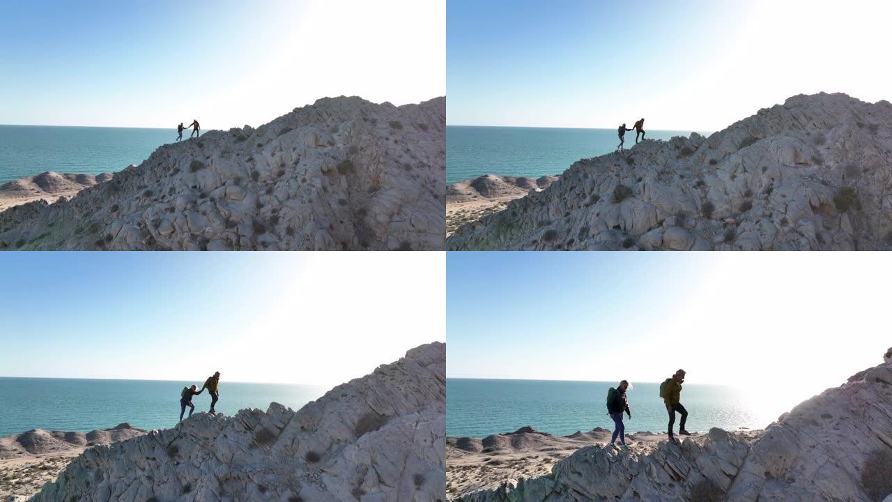成熟的登山夫妇登上沿海山脊的鸟瞰图
