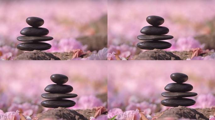 Pebble stones over pink flowers