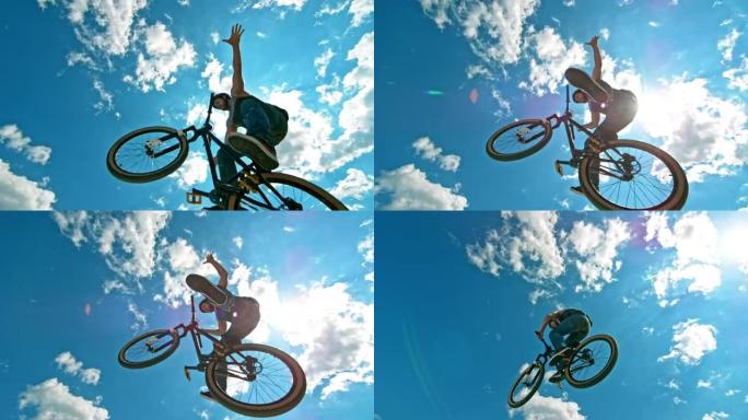 速度坡道骑自行车的人跳入空中，将手和脚从自行车的踏板和车把上移开