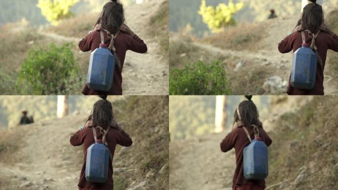 年轻的尼泊尔女孩拿着带头带的水壶