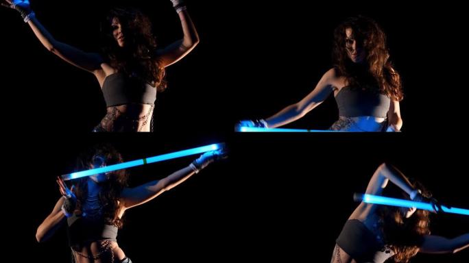 年轻的吉普赛女子在紫外线下跳舞霓虹灯表演