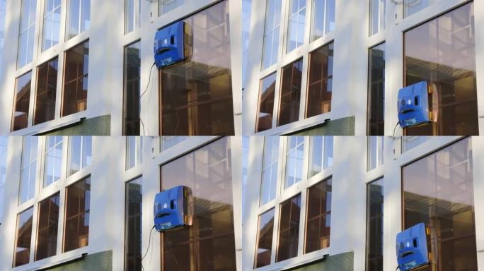 自动机器人洗衣机在屋外的玻璃上垂直移动，使其清洁