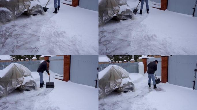 冬天，一个人在房子的院子里打扫雪。