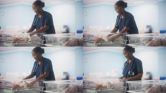 年轻的护士在检查产科病房时用毯子覆盖新生儿。健康婴儿婴儿躺在产科诊所等待母亲分娩后康复