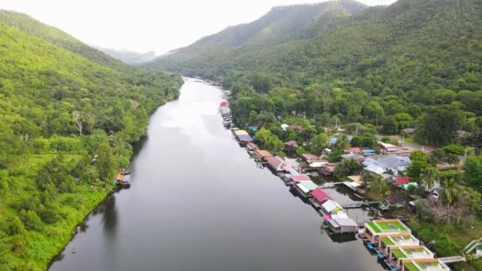 沿河漂流屋绿色自然的鸟瞰图，飞越热带绿色森林和宁静的河流