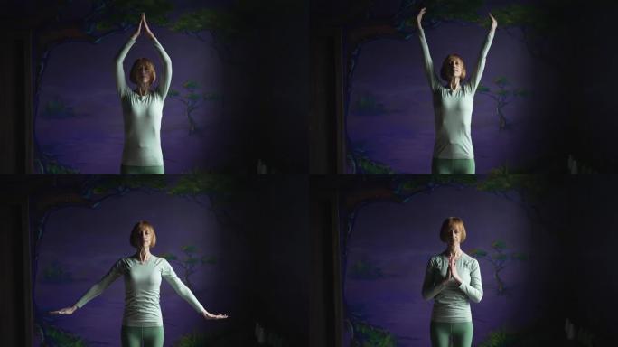 一个女人在紫色的墙壁上练习瑜伽的镜头