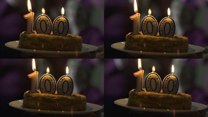 蜡烛在100周年纪念蛋糕上燃烧，订户数量，公司成功