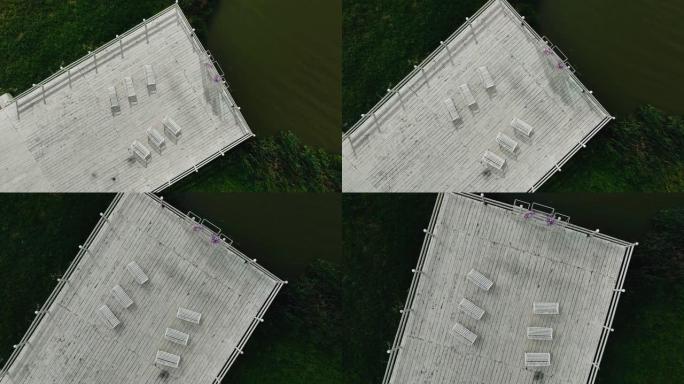 摄像机从空中拍摄了一个美丽的白色码头。码头位于湖畔
