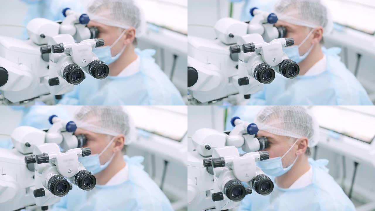 眼科手术专家坐在显微镜前进行手术。低角度视角的女医生进行高精度手术。Femto激光辅助白内障手术。