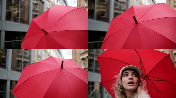 拿着红色雨伞的女人走在镜头前。