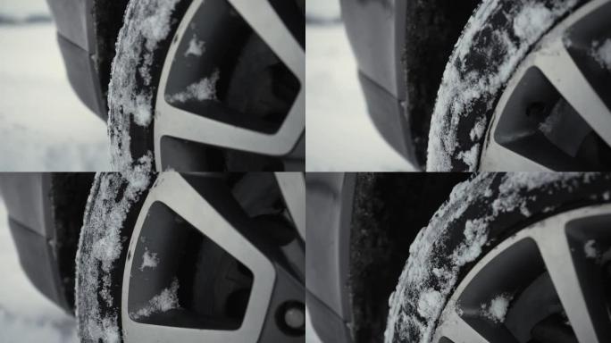 汽车的旋转车轮，在冬天用深雪堆从雪乡道路上未经处理的旋转轮胎