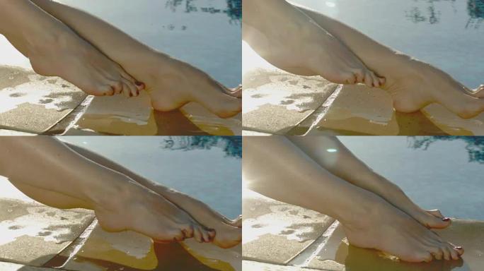诱人的女人在脱毛后坐在游泳池旁，享受腿上柔滑的皮肤