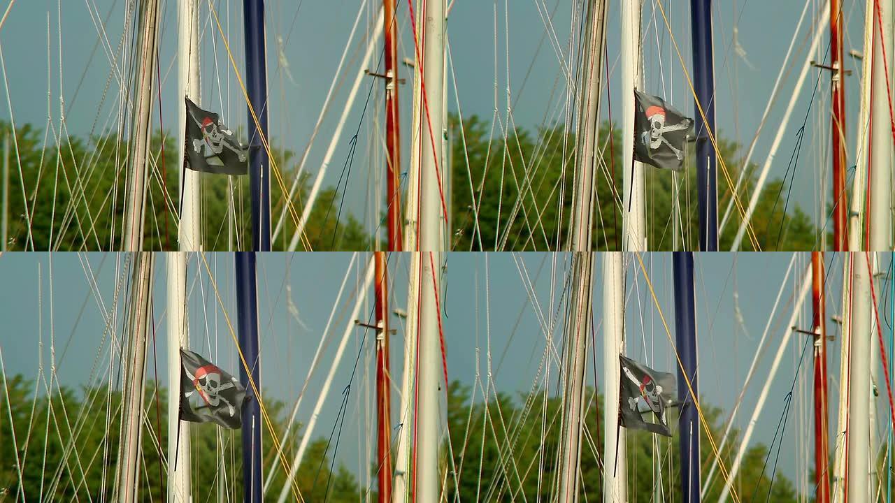 风上的黑色海盗旗，骷髅和交叉骨，游艇