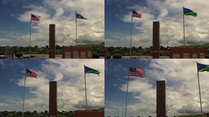 抬头看着战争纪念碑上在微风中飘扬的旗帜。