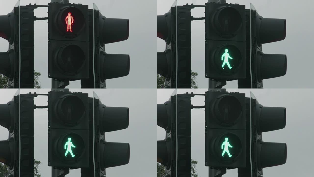 红色交通信号灯变为绿色，允许行人行走。格兰特