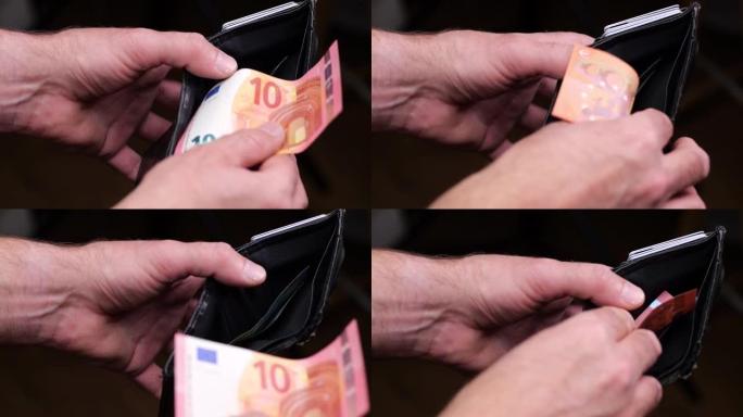 一名男子从钱包里掏出来，数着欧元的钱。男人的手。