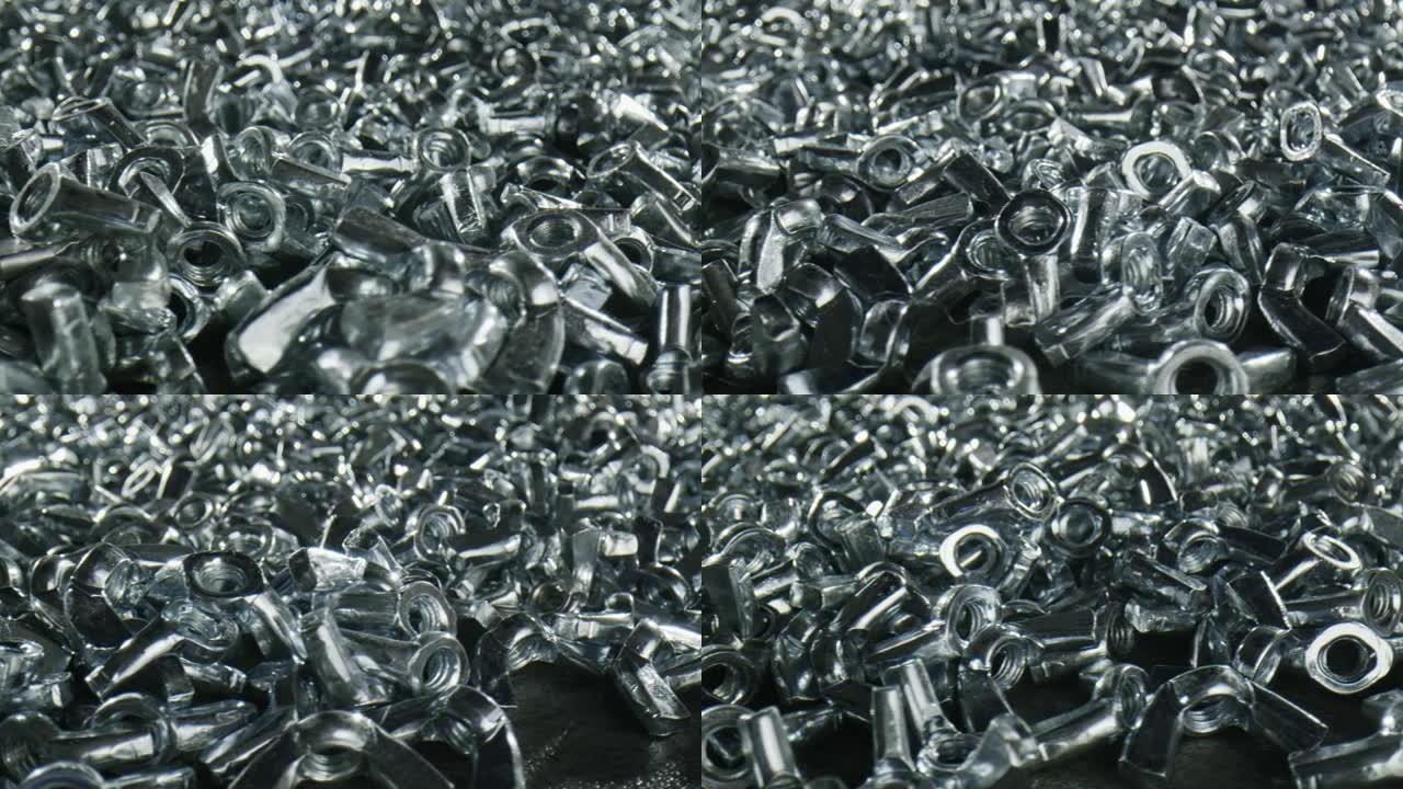 几十个带紧固件的分散金属螺母-特写