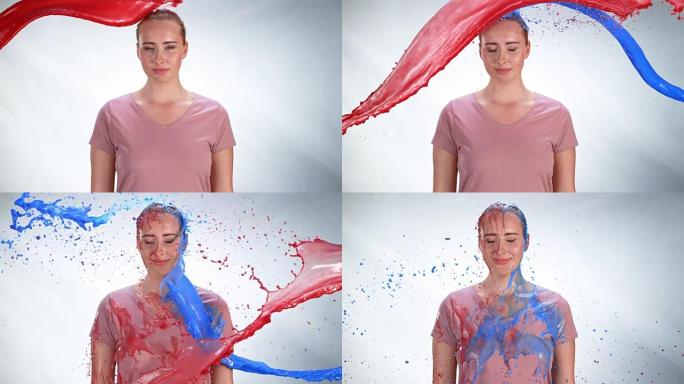 年轻的白人妇女被红色和蓝色油漆淋洗