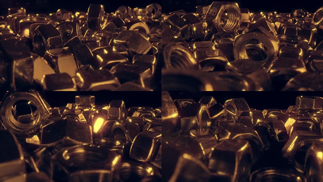 几十个闪闪发亮的小金金属坚果-特写