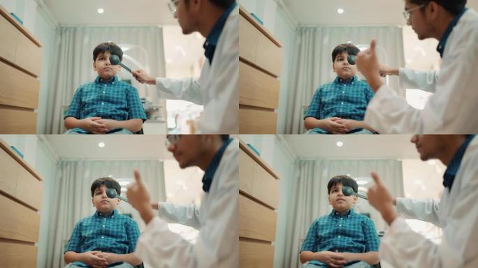 印度男孩在仪器上检查眼科医生的眼睛