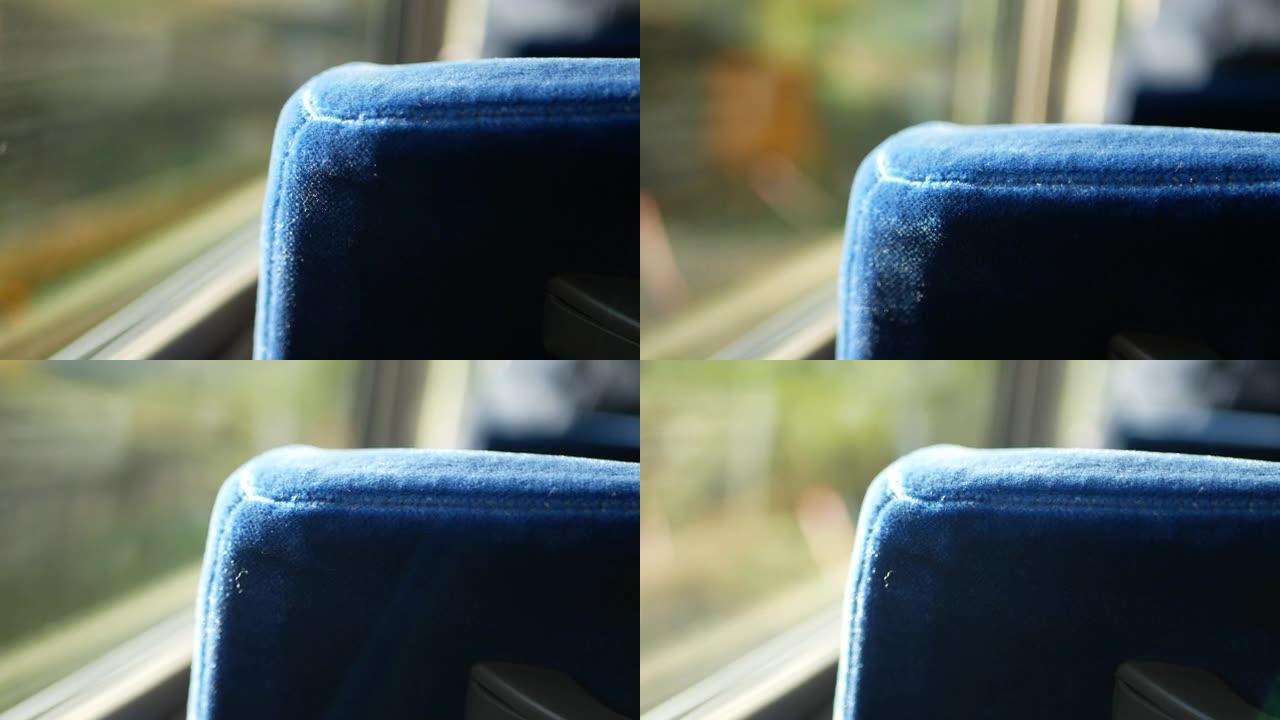 在公交车上的座位上选择性聚焦视图，同时向上移动到山脉山，阳光透过窗户照射