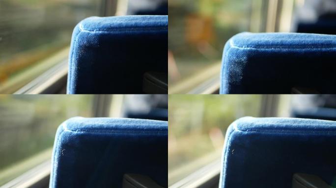 在公交车上的座位上选择性聚焦视图，同时向上移动到山脉山，阳光透过窗户照射