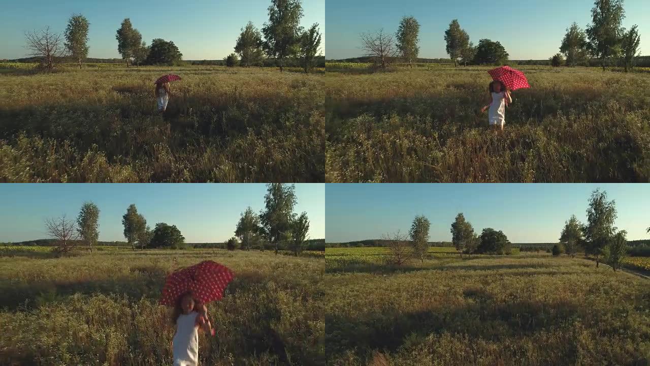 小女孩带着红色的雨伞穿过田野