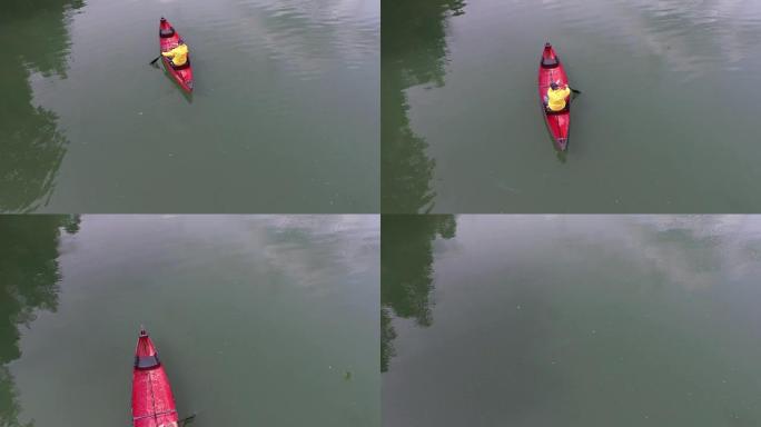 男子在湖中划桨独木舟的空中射击