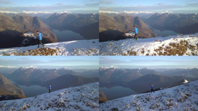 在湖泊和山脉上方的雪山山脊上行驶的步道的鸟瞰图